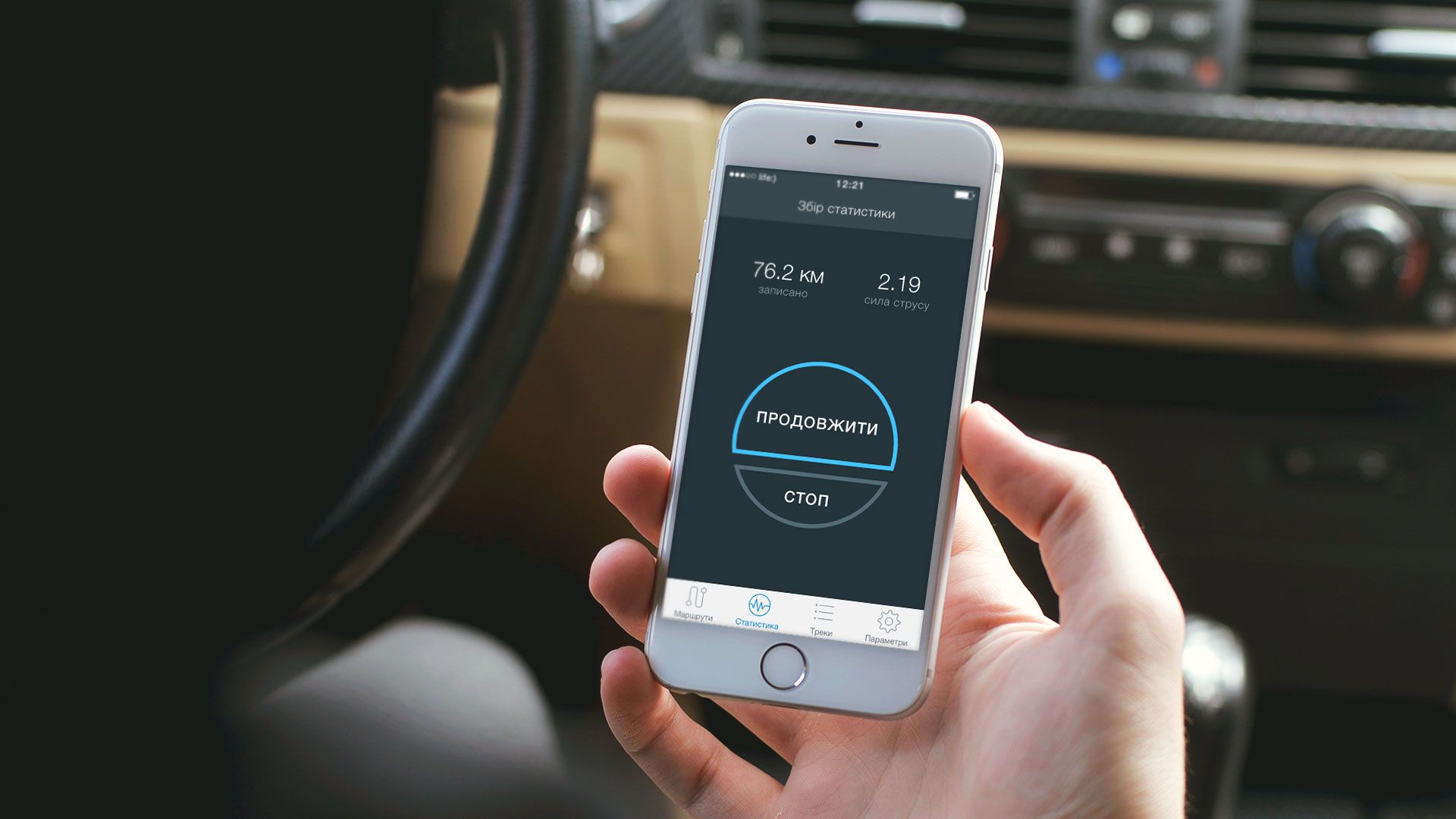 user using a mobile app in a car with distance and time displayed
