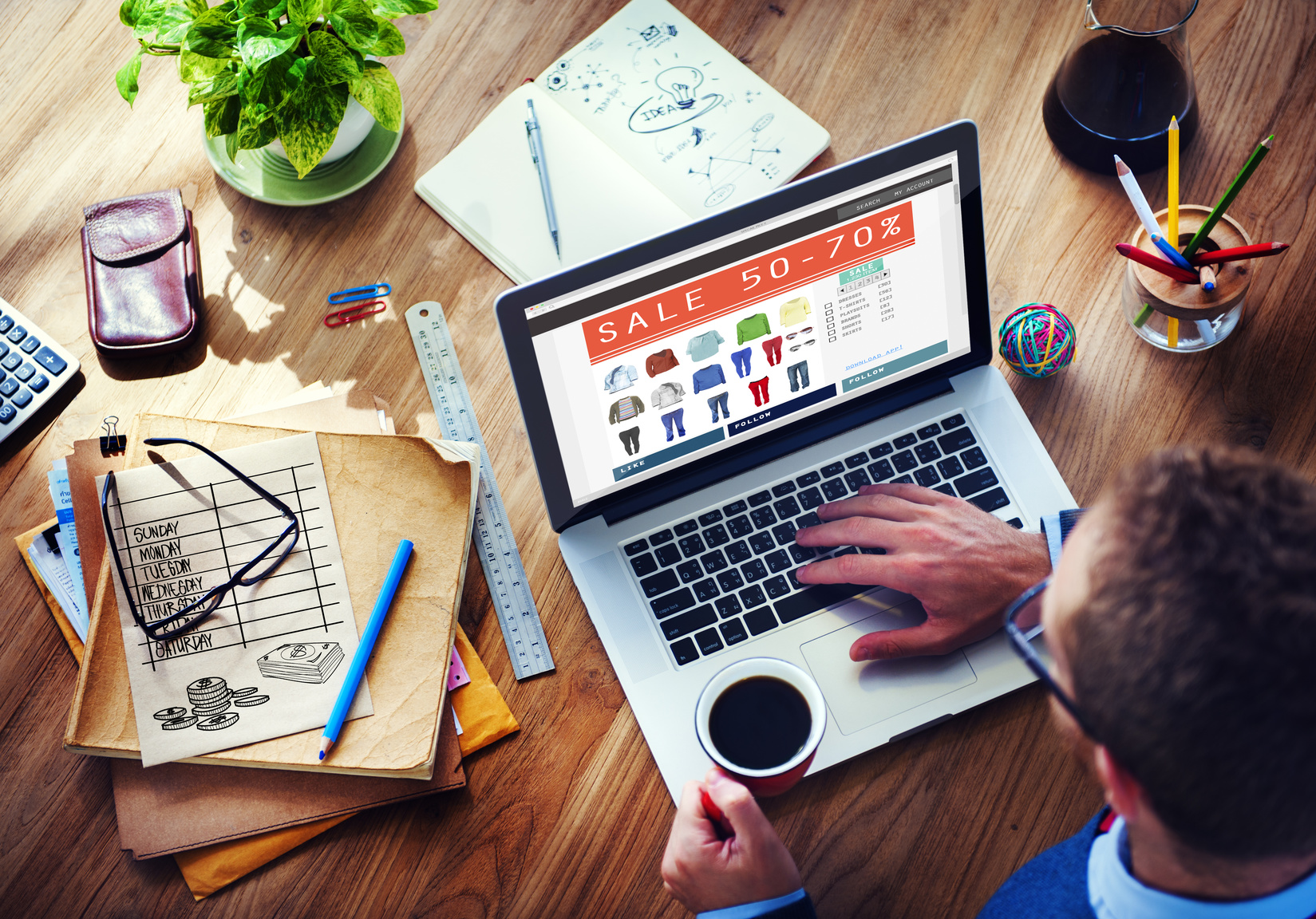 laptop displaying a sale on clothing with 50-70% off