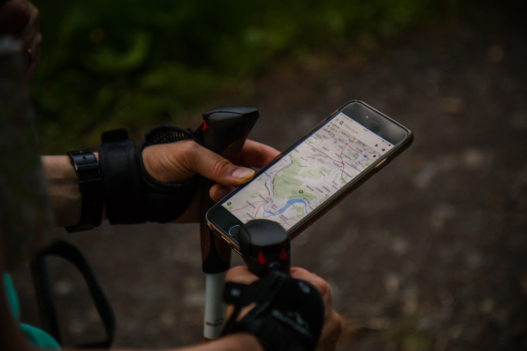 person using a smartphone with a map application outdoors