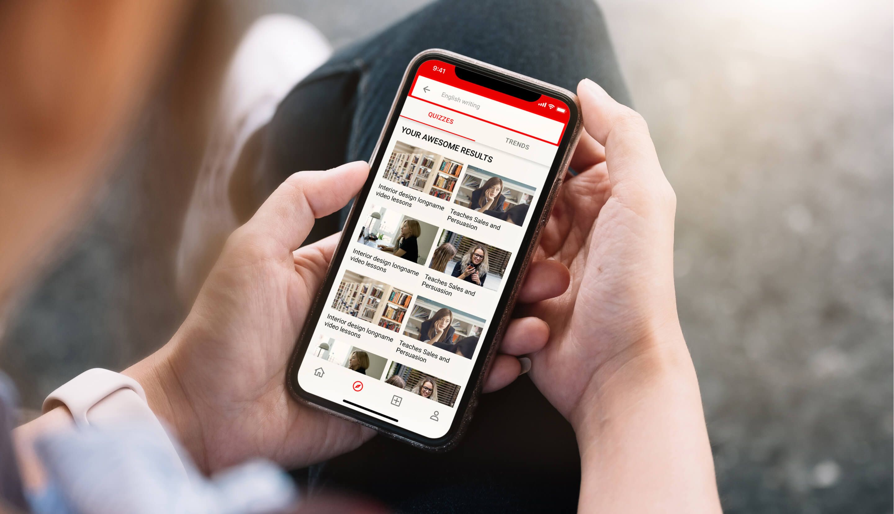 person holding smartphone displaying video streaming results