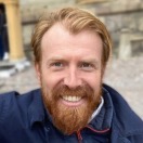 Robin Szekely, Founder of TaskRunner, smiling outdoors